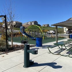 Park at Sherwater St & Raven St - Wide view of play equipment and table area.
