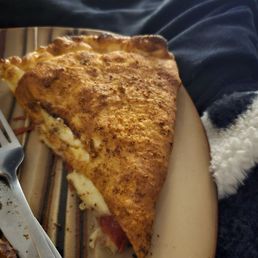 Part of a meat lovers calzone Part of a meat lovers calzone