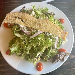 Individual tossed salad. Dressing was super light and flavorful Individual tossed salad. Dressing was super light and flavorful