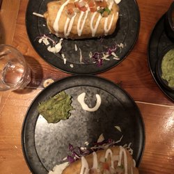 Los Cuervos Taqueria Y Cantina - On top: Chicken/Beef Burrito, on the bottom, my Chickdn Burrito. I how they marked our plates with crema