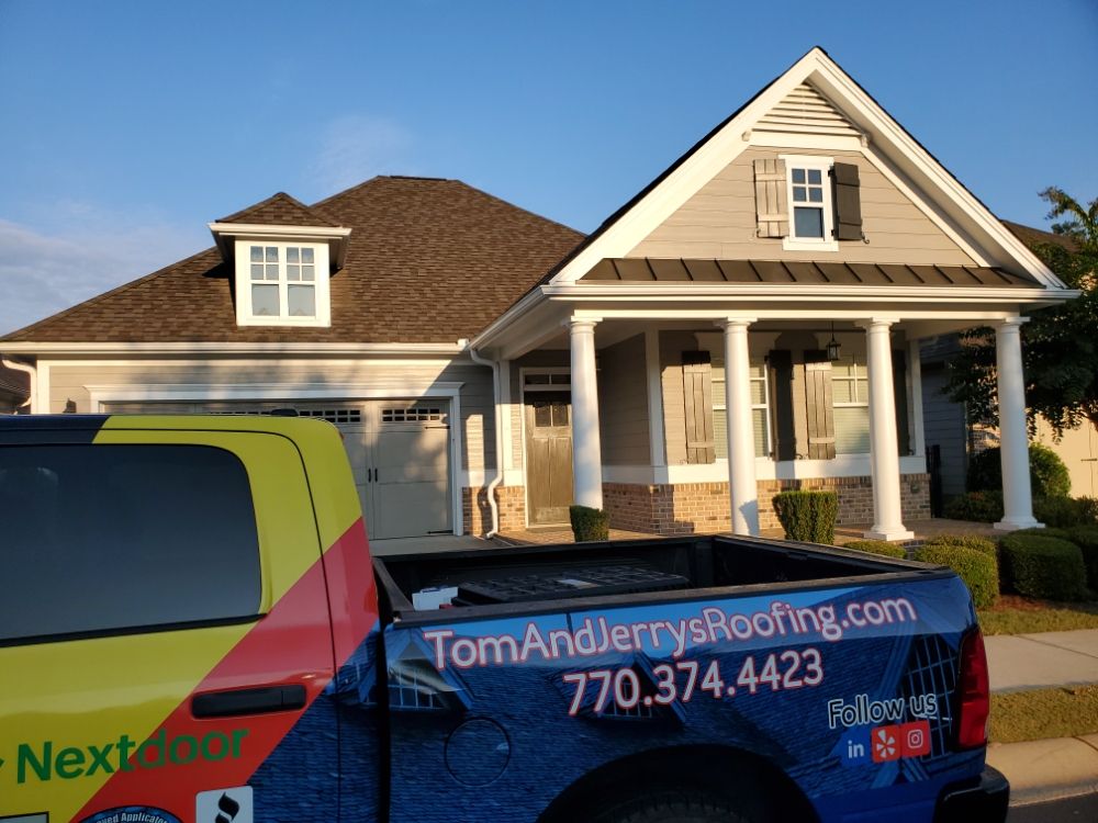 Slide of Tom and Jerry's Roofing