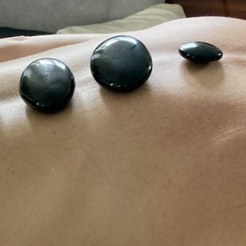 Obsidian Stone Massage - Obsidian working on the spine - Massage Therapy Near Me - Charleston, South Carolina