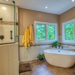 Miller's Fancy Bath & Kitchen - Free-standing bathtub set on angle with corner shelf and ceramic floor tiles