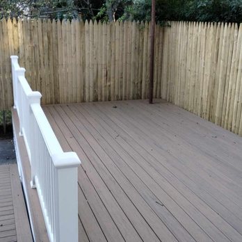 Boston Framers - After completion.  A beautiful, spacious, deck with Antique leather composite and  white railing, also a ramp. - General Contractors Near Me - Natick, Massachusetts