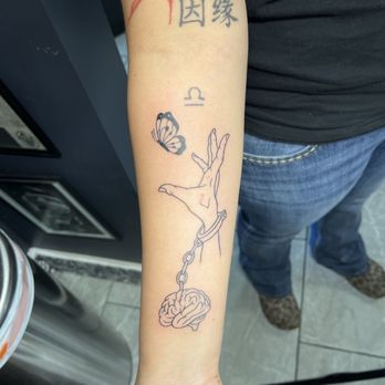 That One Tattoo Parlor - The piece Cade worked on the with the hand reaching for the butterfly chained to the brain - Tattoo Near Me - Glendale, Arizona That One Tattoo Parlor - The piece Cade worked on the with the hand reaching for the butterfly chained to the brain - Tattoo Near Me - Glendale, Arizona