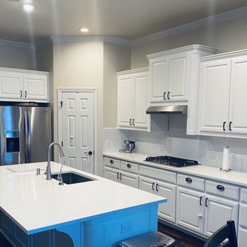 A+ Countertops -  a kitchen with white cabinets - Countertop Installation Near Me