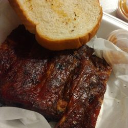 Perry's Original Roadside BBQ & Catering - Rib sandwich. 4 bones with 2 slices of bread and plenty of sauce on the side.