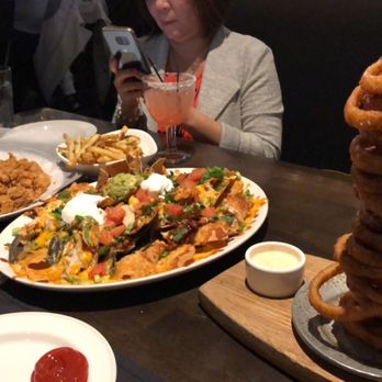 Yard House - happy hour onion rings, chicken nachos (HUGE!!!), calamari and truffle fries - New American Near Me - San Jose, California
