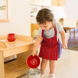 Guidepost Montessori at Timber Ridge - Toddlers (18 mths - 3 yrs) learn practical life skills like table setting, cleaning mirrors, polishing shoes, washing dishes, and more.
