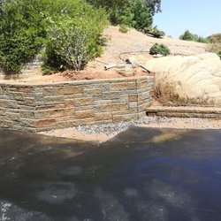 MountainSide Landscaping - A retaining wall we took apart and reinstalled further back to provide space for the home owner to move their RV in and out of the garage.