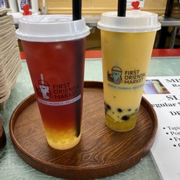 Mango milk tea with boba and jellies and strawberry/raspberry tea with mango popping boba Mango milk tea with boba and jellies and strawberry/raspberry tea with mango popping boba