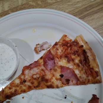 Tornado's Pizza - a half eaten slice of pizza - Pizza Near Me - Belleville, Michigan