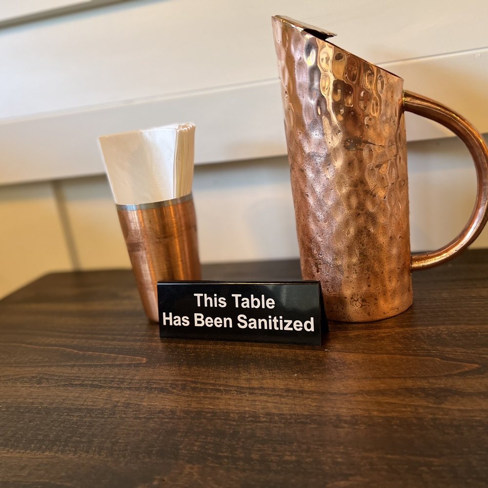 Bel King - a copper pitcher and a glass on a table - Indian Near Me - American Canyon, California
