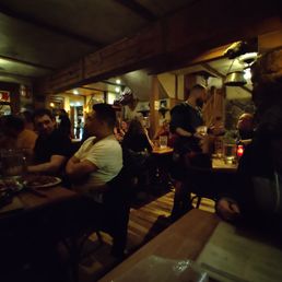 a group of people sitting at a restaurant a group of people sitting at a restaurant