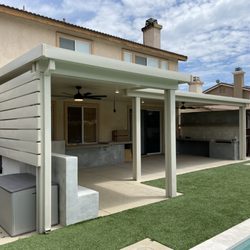 Top Quality Patios - Dual projection patio cover with privacy wall added to one end.