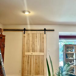 Arkheart Services - Final look- Classic modern natural wood barn door with mute black metal rail, enforced with extra matching wood slab.