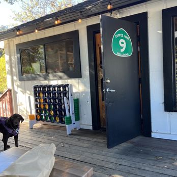 Coffee Nine - a black dog on a porch - Coffee & Tea Near Me - Ben Lomond, California