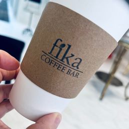 a hand holding a coffee cup a hand holding a coffee cup
