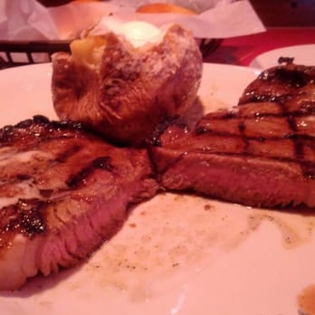 Texas Roadhouse - 10 oz Rib eye (cooked medium) with baked potato and butter. - Steakhouses Near Me - Champaign, Illinois