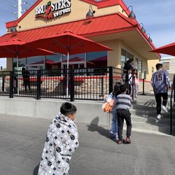 Bruster's Real Ice Cream - Walking up to the store. Order window up front by the red umbrellas, pick up window on the right side