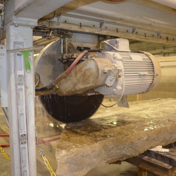 Millennium Granite - a machine cutting a piece of wood - General Contractors Near Me - Wells, Maine