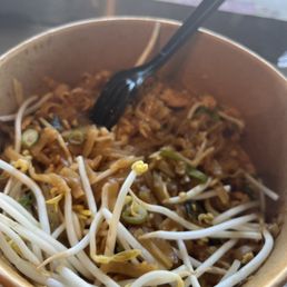 a bowl of noodles with a spoon
