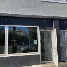 Storefront of new location for watch repair shop.