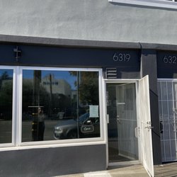 Storefront of new location for watch repair shop.