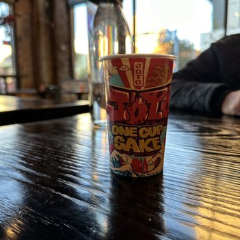 Oni - a cup of coffee on a wooden table - Ramen Near Me - Albuquerque, New Mexico