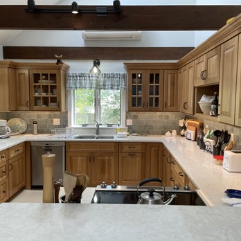 David Ricardi Designs - a kitchen with wood cabinets and white countertops - Interior Design Near Me - Harwich, Massachusetts