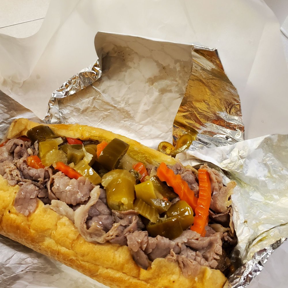 Beef sausage combination sandwich with hot peppers. Beef sausage combination sandwich with hot peppers.