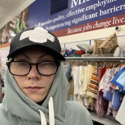 Edmonds Goodwill - Attempting a creative hat try on (Seattle Seahawks cap), Wednesday 5 June 2024.