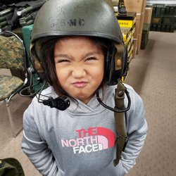Army & Navy Surplus - Baby girl showing her mean face.