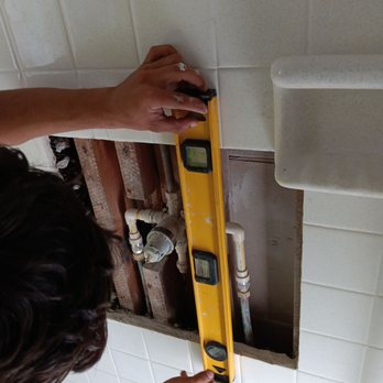 ProClean Maintenance Services - a woman using a level - Flooring Near Me
