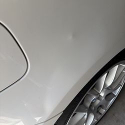 Like New Mobile Dent Repair - Before photo with dented fender and an odd protrusion.