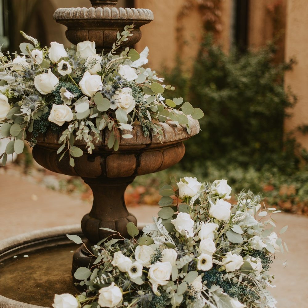 Fluorescence Flowers - Flowers on the fountain outside before she moved them indoors - Florists Near Me - Denver, Colorado