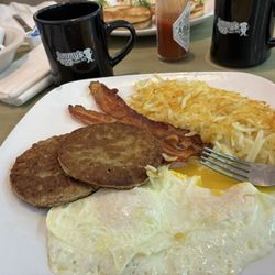Jimmy's Egg Restaurant - Two eggs over easy, bacon, sausage patties, and hash browns. My biscuit and gravy came with this but it's so much I get it to go.