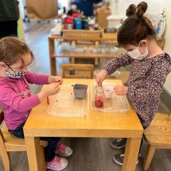 Evergreen Montessori Academy - Children working on practical life Montessori work