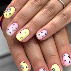 Art Glow Nails - A little cake-inspired sparkle Pastel pink and butter yellow nails with colorful crystals, inspired by Kylie Jenner's birthday cake.