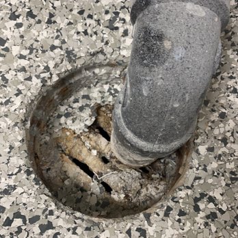 Vittorio Group - Didn't know to tape over the drains - just let epoxy drip and harden on the drains. - General Contractors Near Me