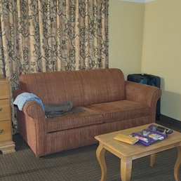 The couch, table and bureau faces the beds The couch, table and bureau faces the beds