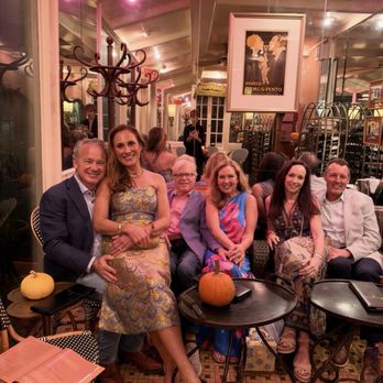 Bayona - The group in glass room - New American Near Me - New Orleans, Louisiana