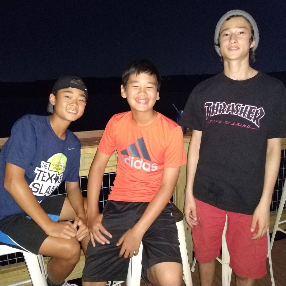 Flying Fish - The boys having a good time feeding fish and enjoying the atmosphere - Seafood Near Me - Coppell, Texas