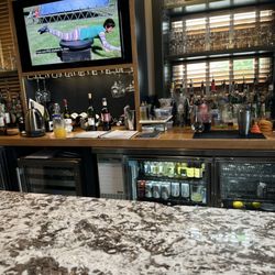 Oak and Front | Kitchen + Bar - Bar with tvs and view of river