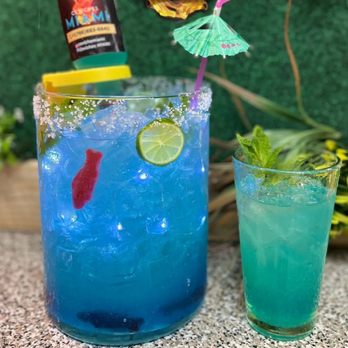 Ceviche Miami - a blue cocktail with a lime garnish - Peruvian Near Me - Hialeah, Florida Ceviche Miami - a blue cocktail with a lime garnish - Peruvian Near Me - Hialeah, Florida
