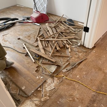 Absolute Flooring - a pile of wood in a room - Flooring Near Me Absolute Flooring - a pile of wood in a room - Flooring Near Me