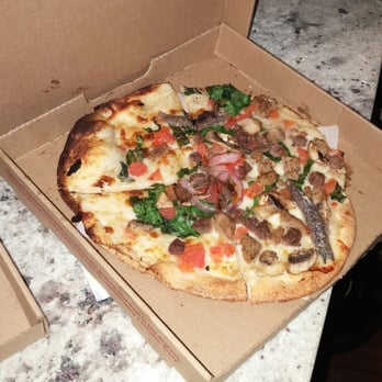 MOD Pizza - White sauce, mozzarella cheese, ground beef, mild sausage, anchovies, basil, mushrooms, red onion, tomato, & spinach - Pizza Near Me - Kyle, Texas
