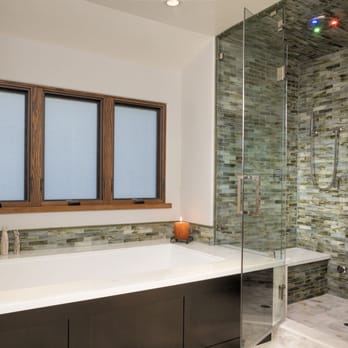 Tile Plus - Limestone and marble covered shower. - Flooring Near Me