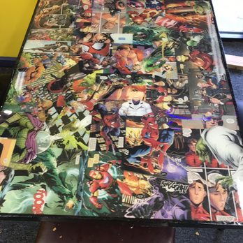 The Bulldog - a table covered in comics - Hot Dogs Near Me - Alpena, Michigan