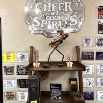 Outlaw Distillery - a shelf with a beer and good spirits sign - Distilleries Near Me - Tempe, Arizona